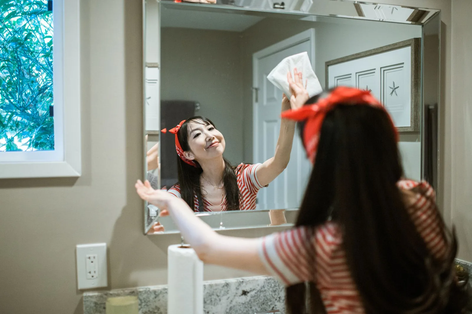 Person cleaning a bright modern home with professional supplies