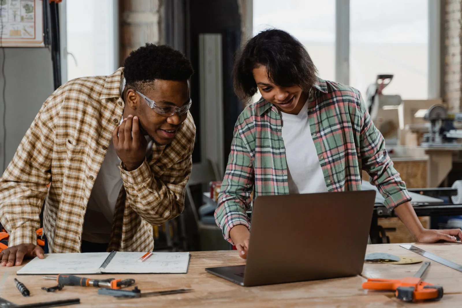 Small business owners comparing website builders on a laptop