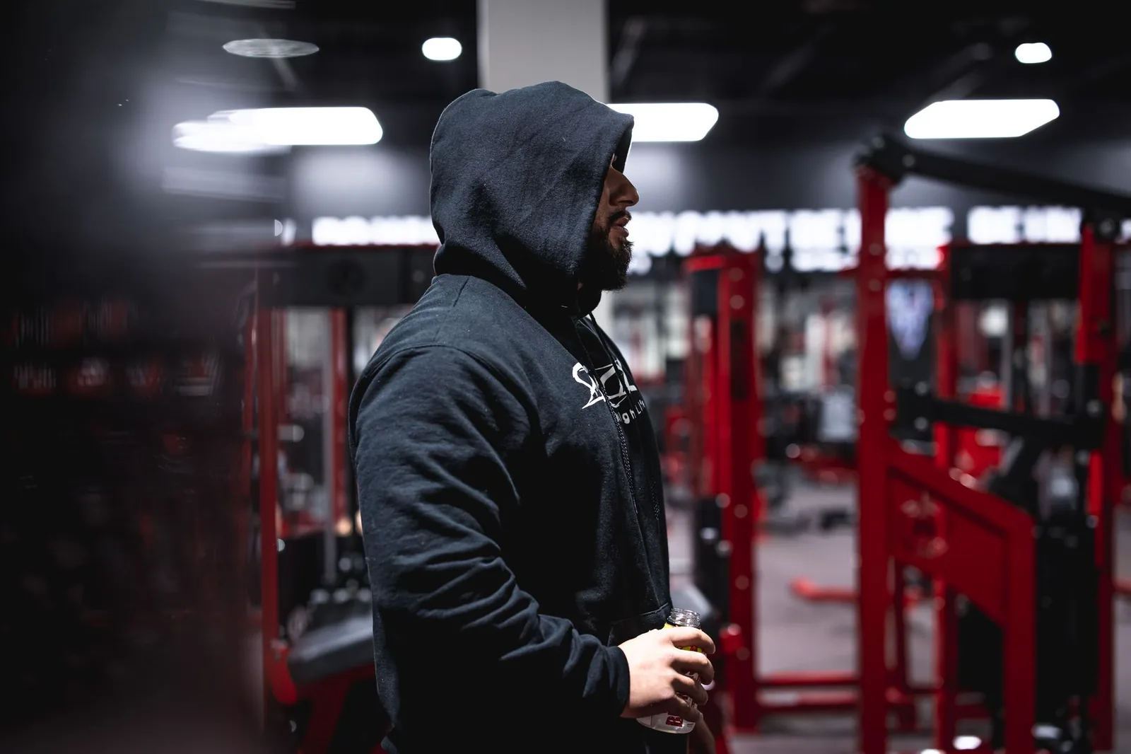 Athlete in training apparel resting in a modern gym, in the high-energy style Gymshark is known for