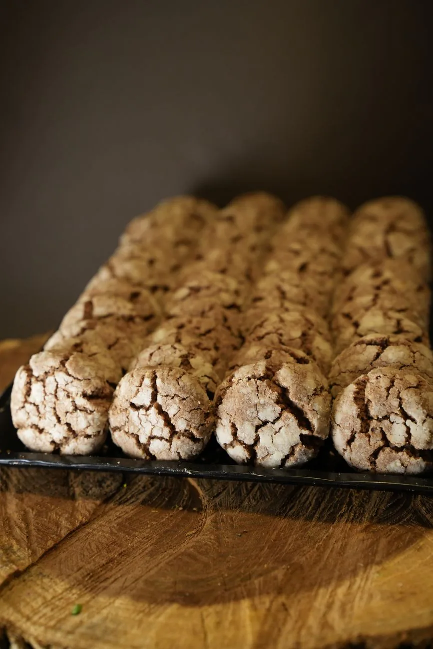 Freshly baked cookies on a wooden slab, in the warm approachable style Partake Foods uses