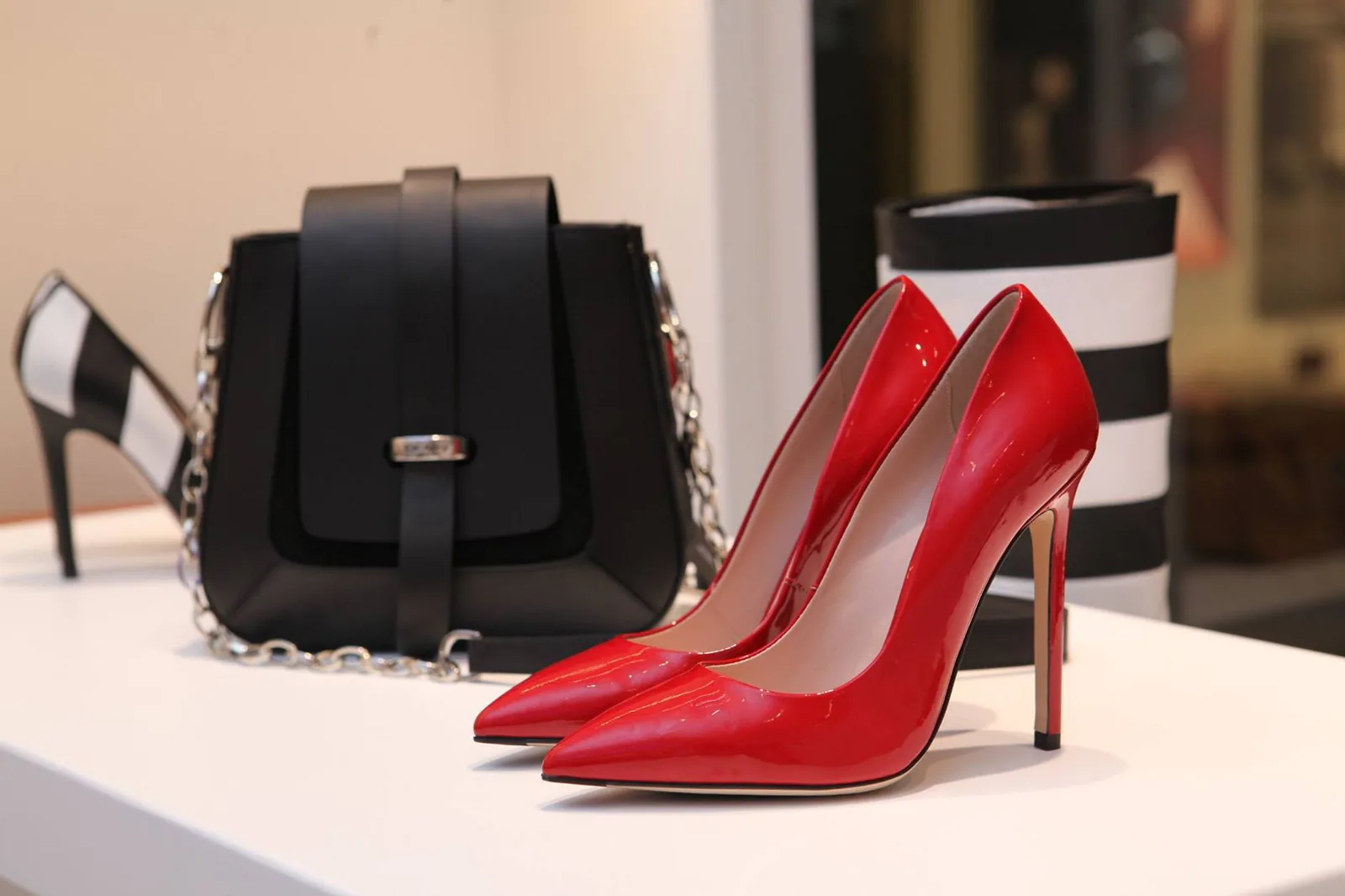 Heels and a handbag displayed in a boutique, in the fashion-forward style Steve Madden is known for