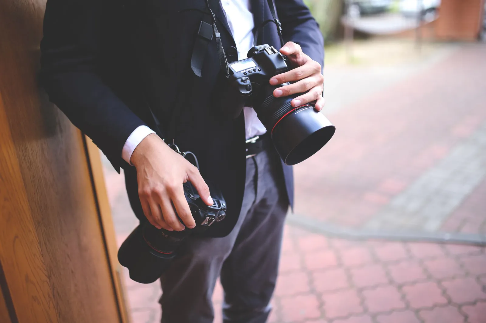 Photographer holding a professional camera during an outdoor shoot