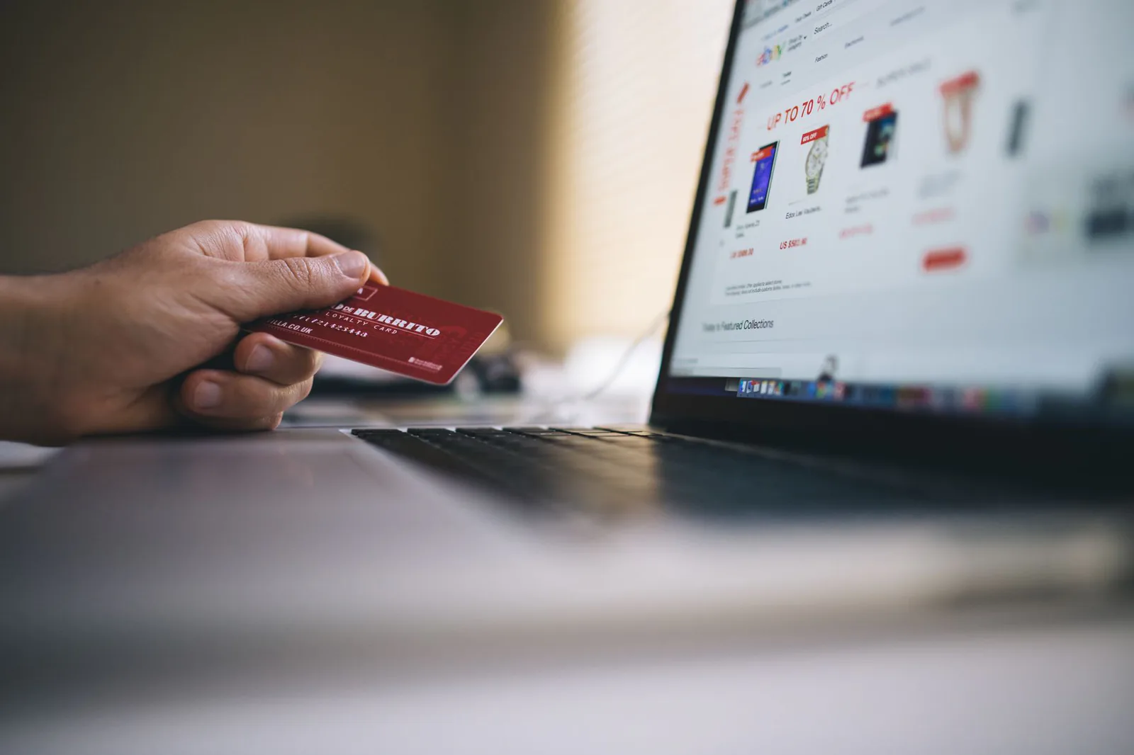 Shopper browsing an online store on a laptop with a credit card