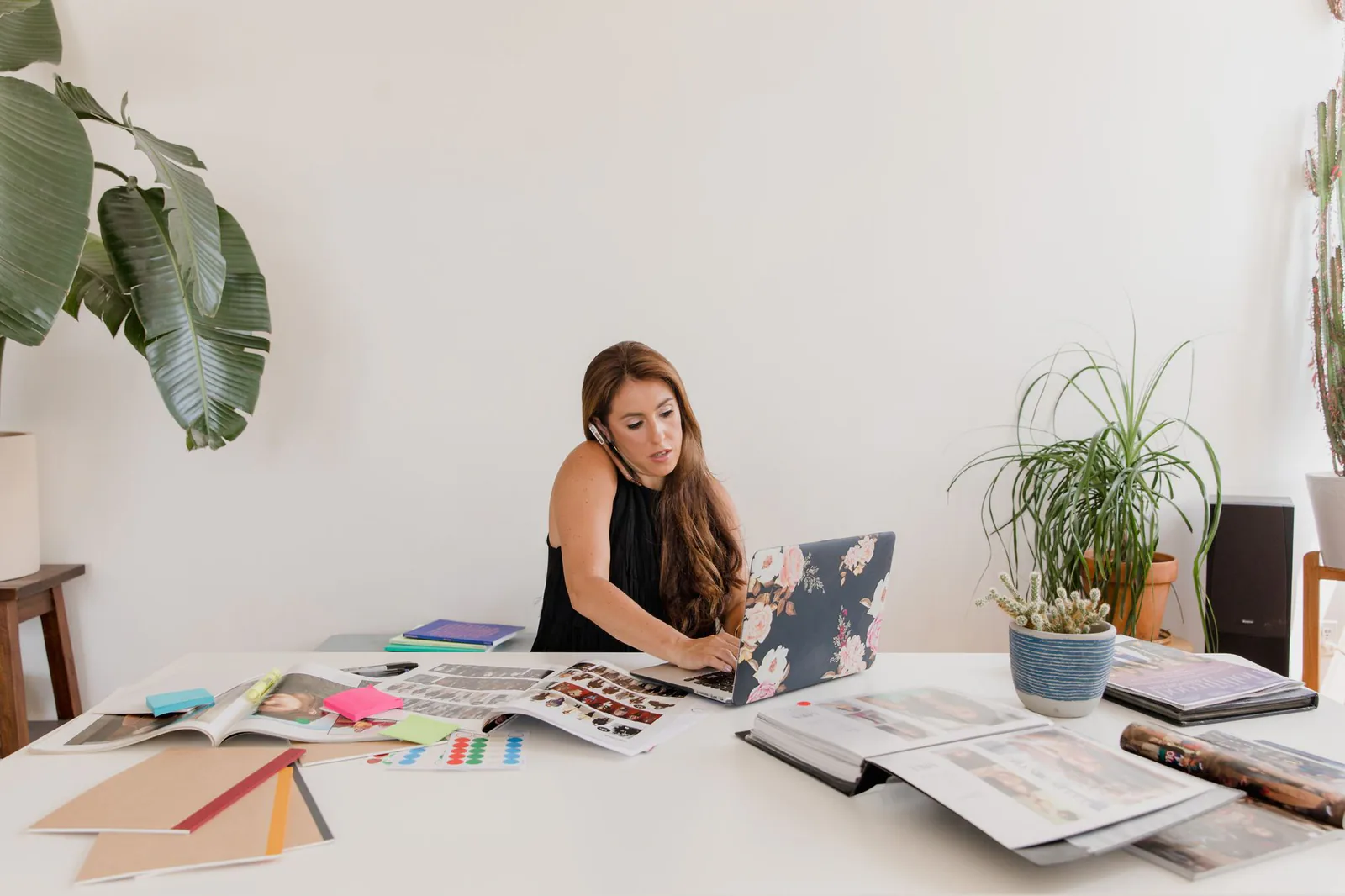 Small business owner designing a custom website on a laptop in a home office